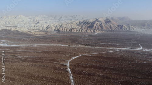 arid desert mountains. Aerial view from drones to dry mountains. Vast open desert landscape. Clay mountains Earth destroyed by erosion and global warming