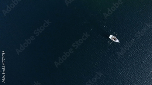 Aerial view of the blue lake and green forests. Lake and boat view