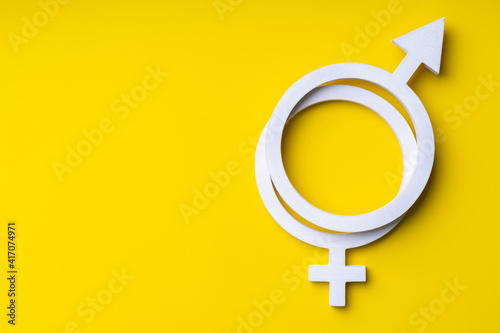 Gender equality symbol on yellow background, copy-space