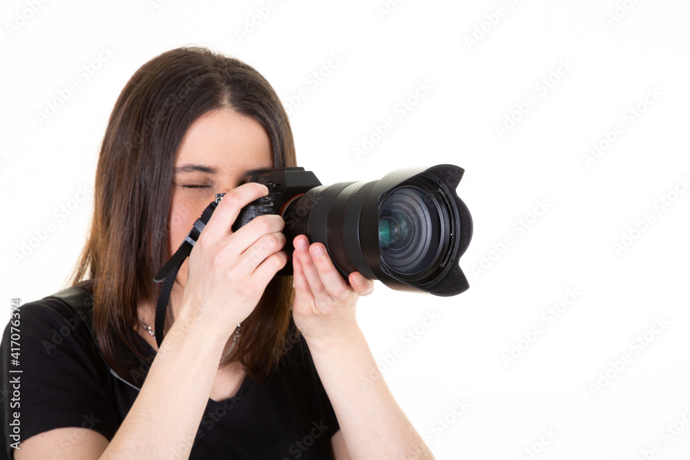 Young woman with black professional digital SLR camera on white background Young woman with black professional digital SLR camera on white background