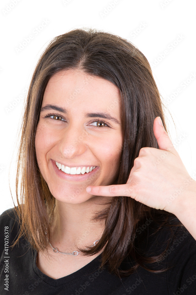 Woman doing phone gesture call me back with hand and fingers like talking on phone isolated on white background Woman doing phone gesture call me back with hand and fingers like talking on phone isolated on white background