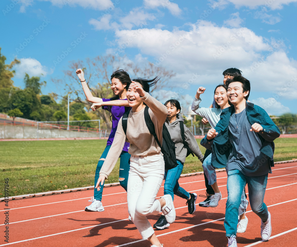 Happy young group student running in the campus Happy young group student running in the campus