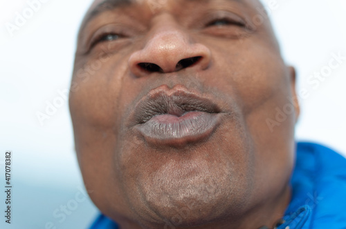 black man sending a kiss with full lips. selective focus