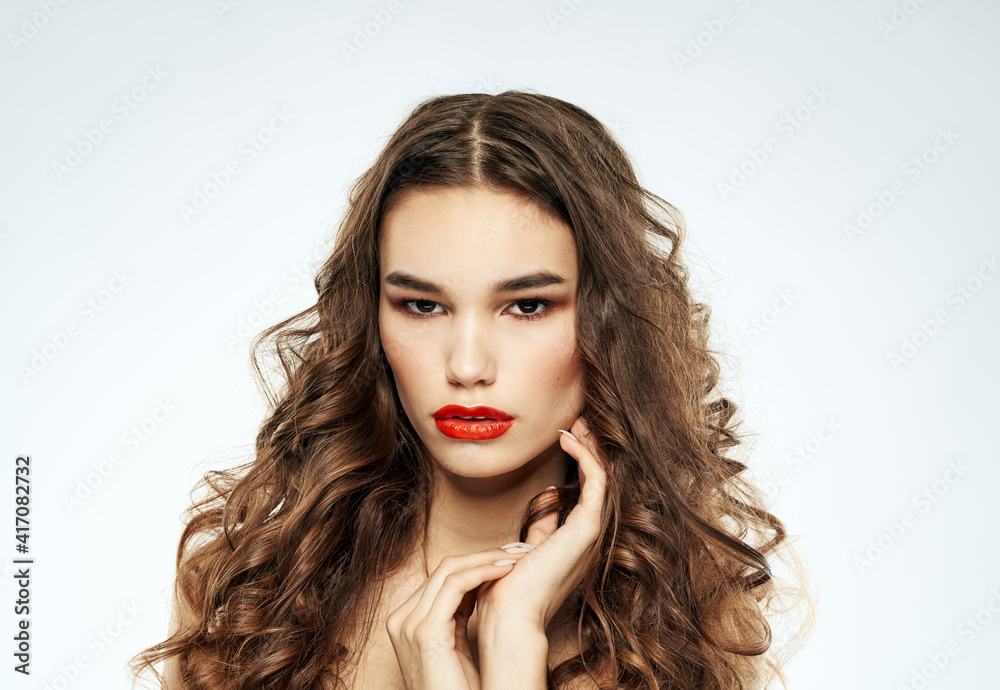 Fototapeta premium Beautiful woman red lips with eyeshadow and curly hair