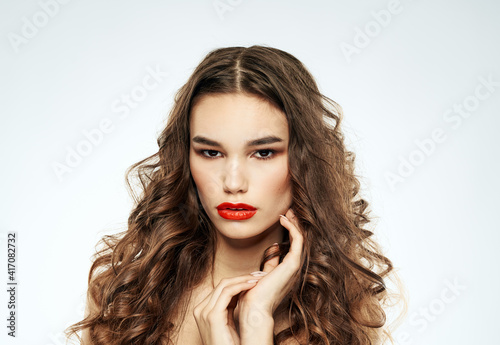 Beautiful woman red lips with eyeshadow and curly hair