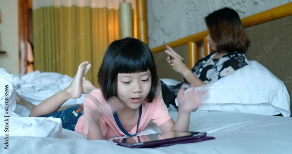 kid watching tablet on the bed, child addicted cartoon kid watching tablet on the bed, child addicted cartoon