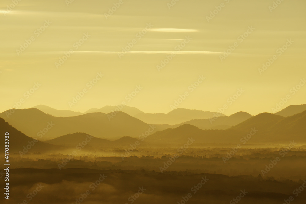 Landscape Arrange Mountains hill with mist fog in the morning sunrise  - nature scenery from  Phuthok Chaing Khan Loei Thailand  , yellow nature image background and Backdrop