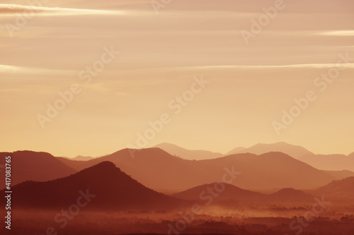 Landscape Arrange Mountains hill with mist fog in the morning - nature scenery from Phuthok Chaing Khan Loei Thailand , dark red nature image background and Backdrop