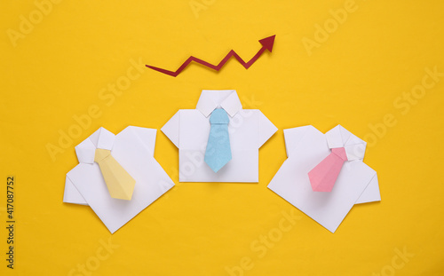 Origami shirts with ties and growth arrow.on yellow background. Leadership, teamwork, business concept © splitov27