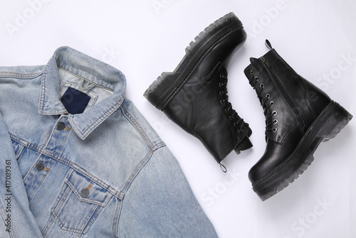 Clothes and footwear. Denim jacket and leather boots on white background