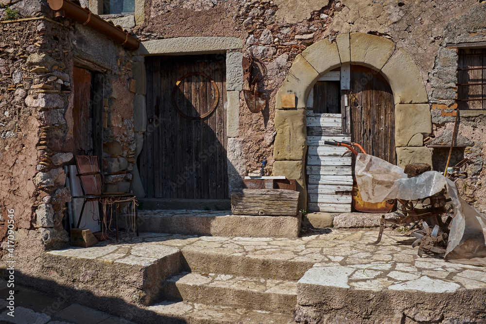 country stone house with peasant tools in a typical Sicilian village country stone house with peasant tools in a typical Sicilian village