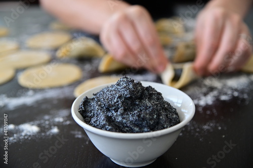 Jewish woman preparing Hamantash cookies with Poppy seeds cream photo