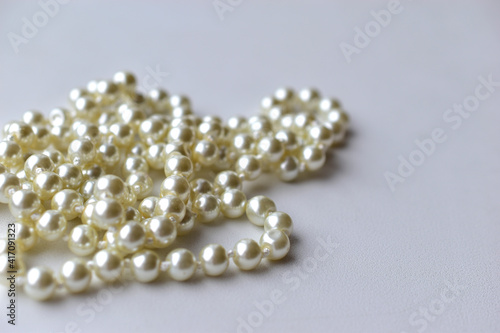 White pearl necklace beads on white background