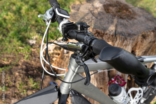 Mountain bike handlebar with hydraulic brake lever with mineral oil inside and derailleur lever. © Michal