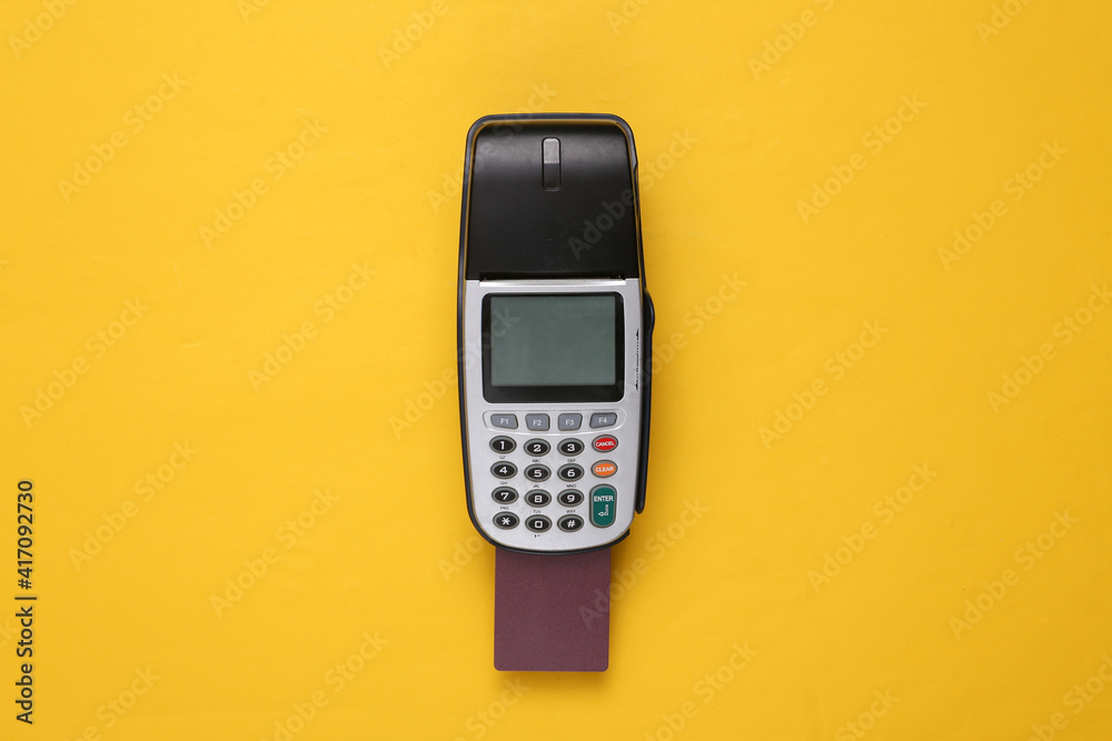 Payment terminal with bank card on yellow background. Payment terminal with bank card on yellow background.