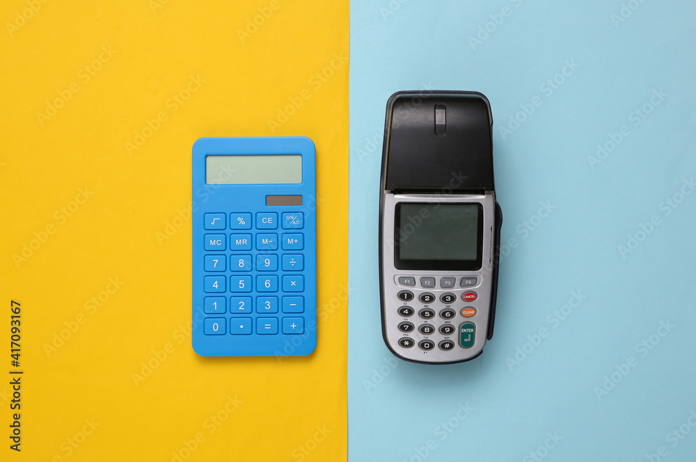 Payment terminal and calculator on blue yellow background. Top view Payment terminal and calculator on blue yellow background. Top view