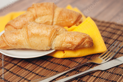 crispy croissants on a plate kitchen utensils for breakfast meal dessert