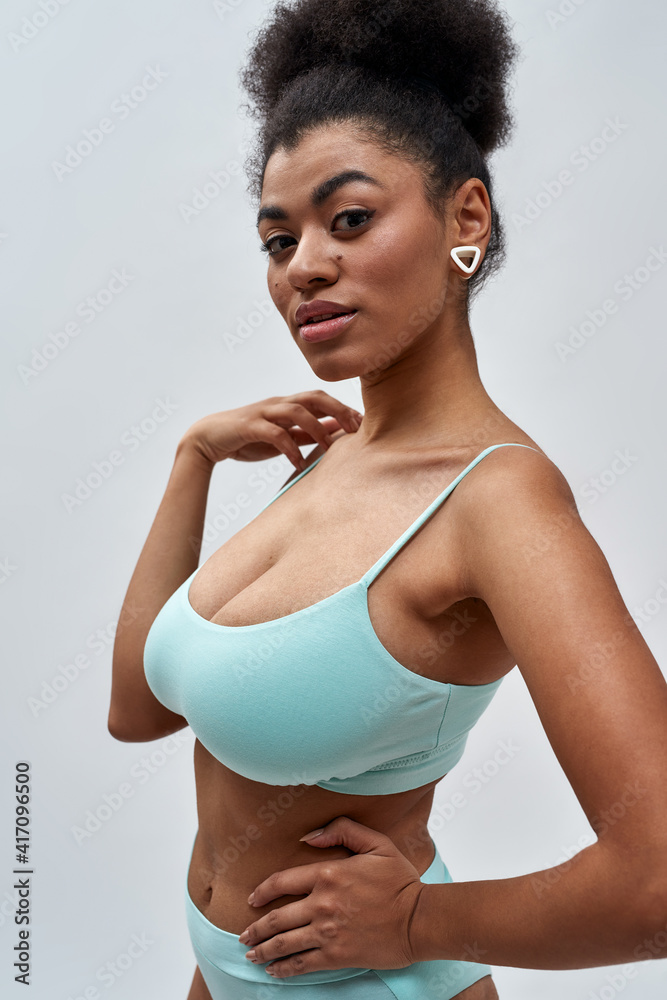 Portrait of sexy young mixed race woman wearing blue underwear looking at  camera, posing isolated over light background Stock-Foto | Adobe Stock