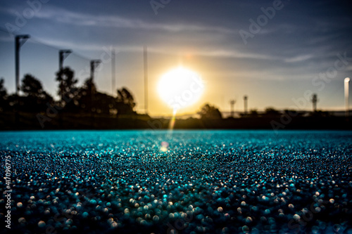 Field Hockey Silhouette on Blue Astroturf