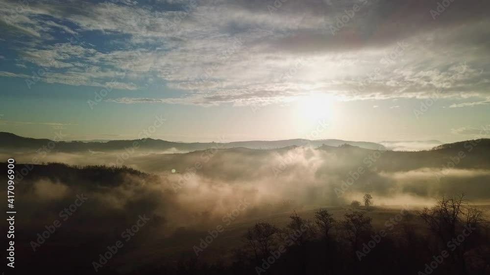Drone view of hills in Transylvania at sunset. Panoramic view of hilly area near Sighisoara, Romania with fog and trees. Drone view of hills in Transylvania at sunset. Panoramic view of hilly area near Sighisoara, Romania with fog and trees.
