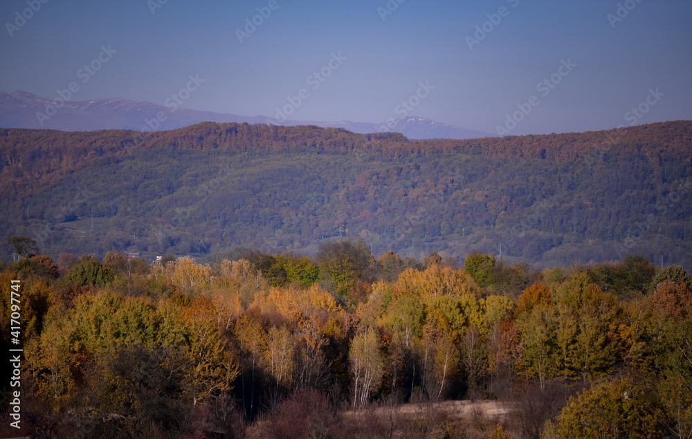 autumn landscape overlooking the horizon where the ridges of the high mountains can be seen. high hills full of dense forests autumn landscape overlooking the horizon where the ridges of the high mountains can be seen. high hills full of dense forests