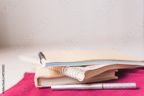 Notebook stack, pen, pencils. Schoolchild and student studies accessories. Back to school concept.