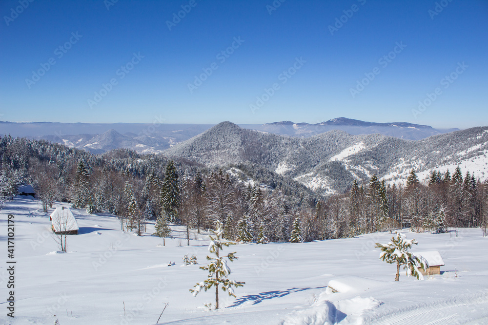 Beautiful winter landscape from the Serbian mountain Tara. View of the snow-capped distant hills.