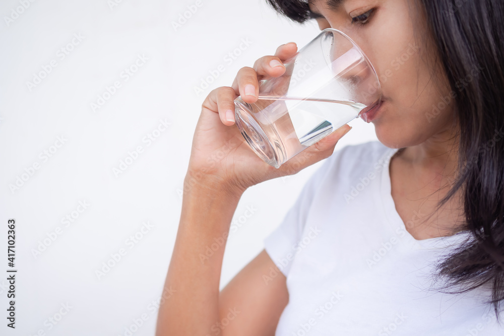 Asian womna drinking water on white background. pure water drink for good health. lady authentic skin tan. Asian womna drinking water on white background. pure water drink for good health. lady authentic skin tan.