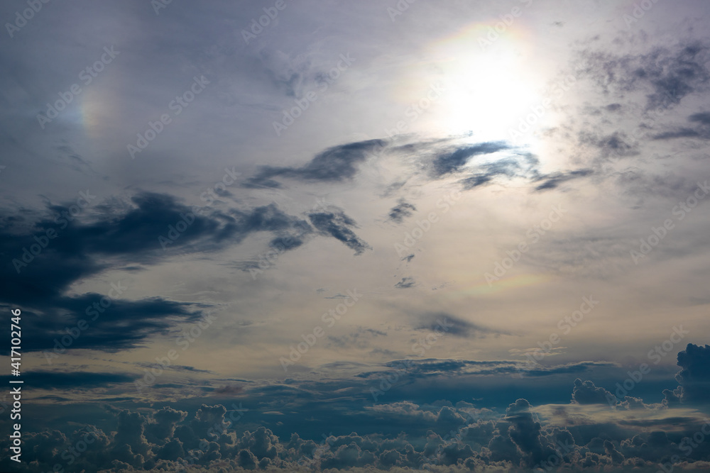 Dark gray sky with clouds and sun in top right corner Dark gray sky with clouds and sun in top right corner