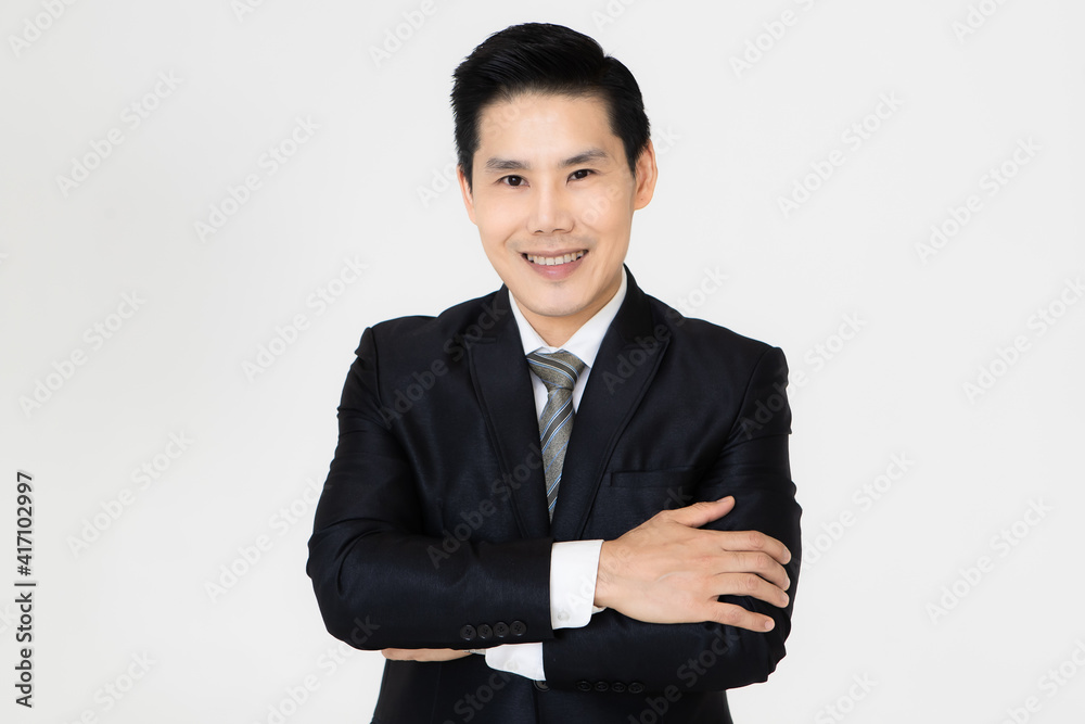 Young and handsome black hair Asian businessman in dark tone suit standing and looking to camera, pose with self-confidence and trust Young and handsome black hair Asian businessman in dark tone suit standing and looking to camera, pose with self-confidence and trust