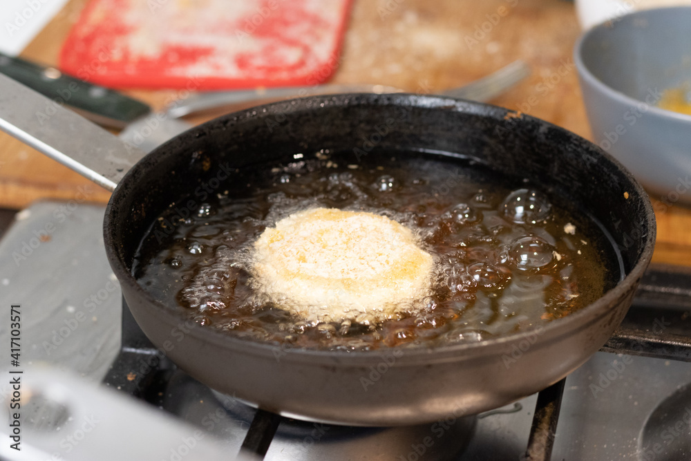Frying chicken nuggets in oil on a frying pan Frying chicken nuggets in oil on a frying pan