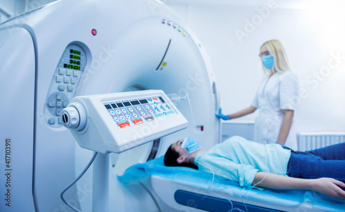 Radiologist with a female patient in the room of computed tomography