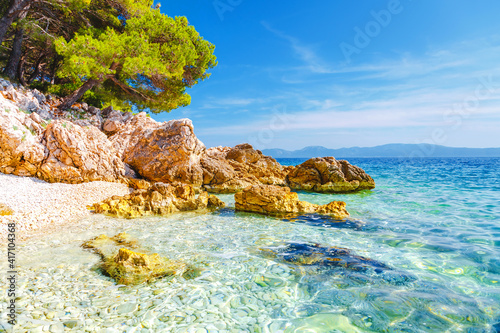 Fototapeta Naklejka Na Ścianę i Meble -  Cozy and wild beach with azure water in luxurious lagoon. Location place Croatia, Dalmatia region, Balkans, Europe.