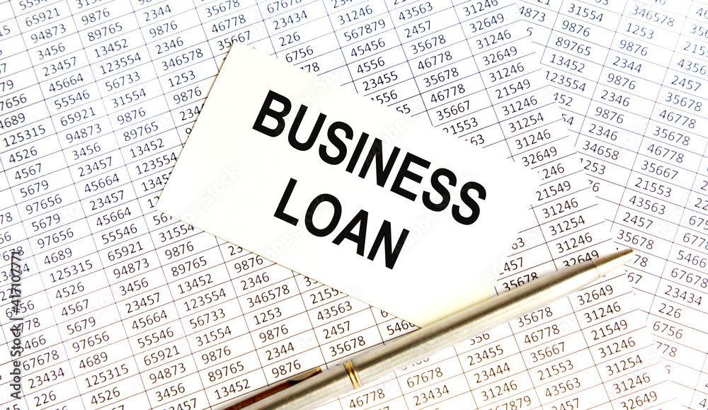 On the business card the text of Business Loan, next to the pen, the background are reports. On the business card the text of Business Loan, next to the pen, the background are reports.