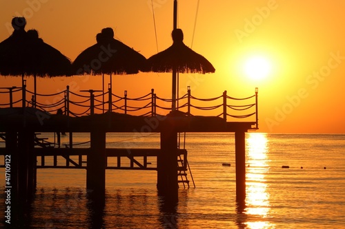 
The silhouette of the pier against the background of the sunset and the Mediterranean sea.