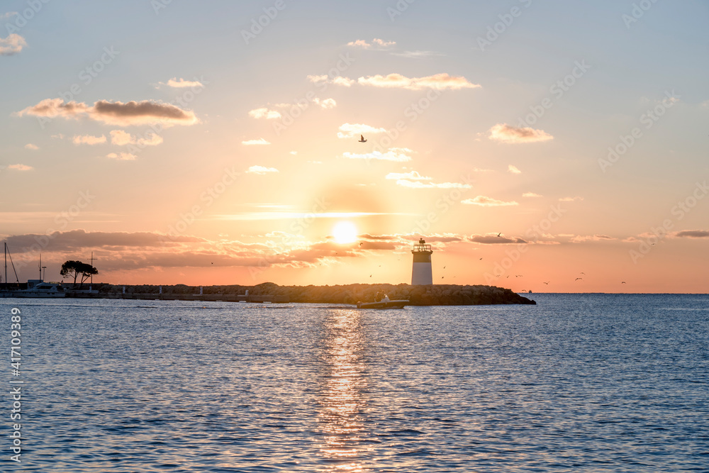 Morning view of the lighthouse and yacht port. Mediterranean sea of french riviera during sunrise. High quality photo