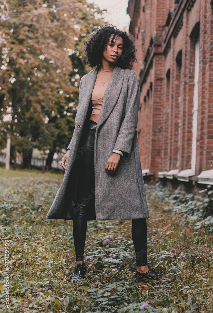 African american model woman posing near brick building African american model woman posing near brick building