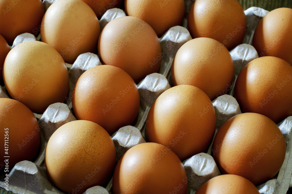 Raw fresh egg in carton container closeup. Low shallow focus Raw fresh egg in carton container closeup. Low shallow focus