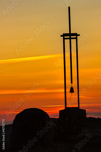 Vertical photo of silhouette of memorial for children lost in shipwreck of ferryboat Estonia and a rock during beautiful sunset on Tahkuna peninsula, Hiiumaa island, Moonsund archipelago, Estonia photo