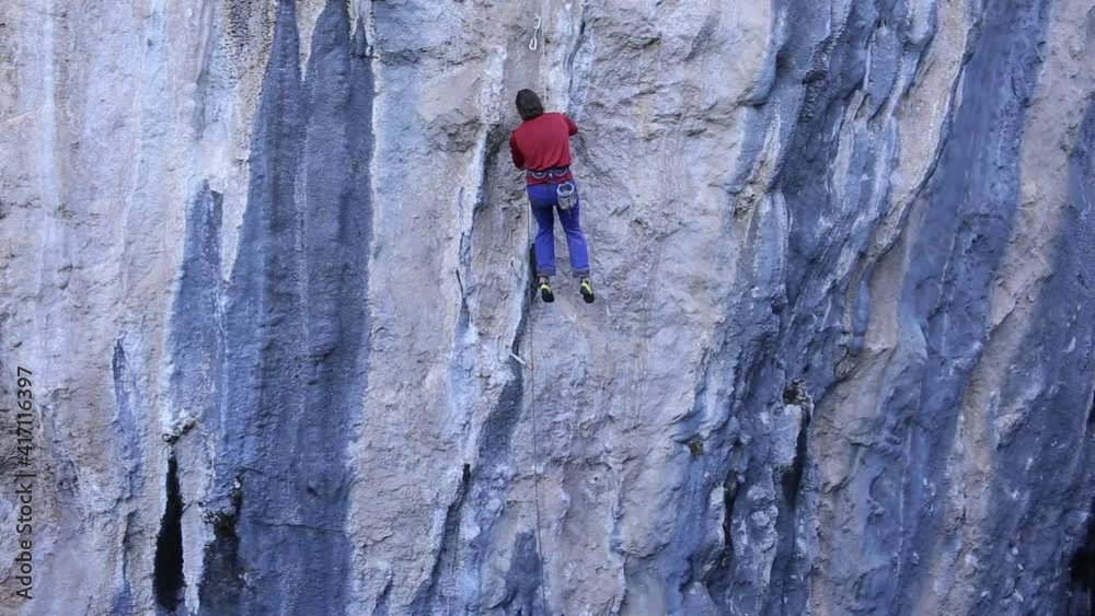 the climber clears the holds on the route for better friction. preparation of the route for passing the climber clears the holds on the route for better friction. preparation of the route for passing