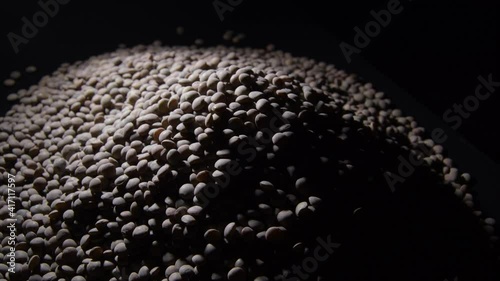 Raw lentils mountain with black background gyrating, rotation photo