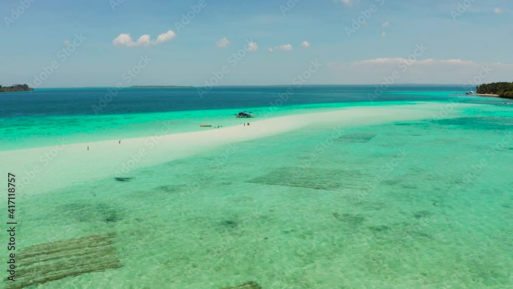 Seascape with a beautiful beach and tropical island surrounded by a coral atoll with turquoise water. Mansalangan sandbar. Summer and travel vacation concept. Balabac, Palawan, Philippines. Seascape with a beautiful beach and tropical island surrounded by a coral atoll with turquoise water. Mansalangan sandbar. Summer and travel vacation concept. Balabac, Palawan, Philippines.