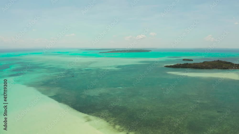 Tropical islands with coral reefs in the blue water of the sea, aerial view. Balabac, Palawan, Philippines. Summer and travel vacation concept. Tropical islands with coral reefs in the blue water of the sea, aerial view. Balabac, Palawan, Philippines. Summer and travel vacation concept.