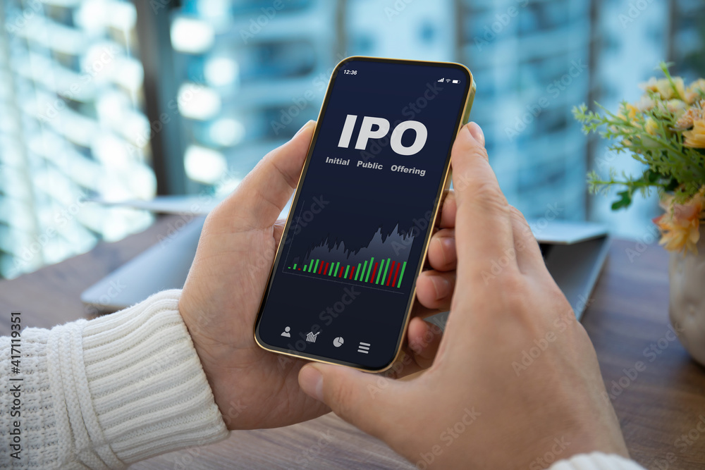 male hands hold phone with IPO stocks purchase app male hands hold phone with IPO stocks purchase app
