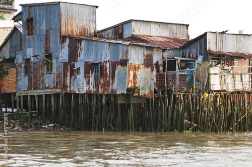 Funky old rundown waterfront warehouse buildings with rusty corrugated metal siding and dozens of wooden pilings underneath