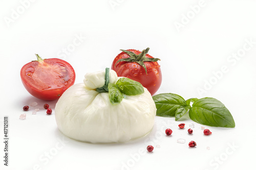 Soft cheese on a white plate with tomato