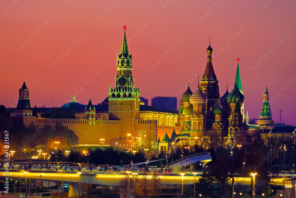 Sunset over the Moscow Kremlin, Russia. Moscow city skyline, cityscape. Bridge in the park Zaryadye. Moscow Kremlin, Cathedral of Vasily the Blessed, Spasskaya Tower