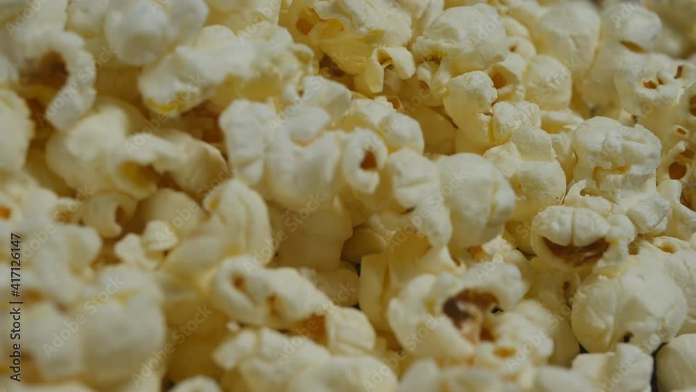 a lot of popcorn falls into a heap. Close-up, slider, dolly cart, 4k a lot of popcorn falls into a heap. Close-up, slider, dolly cart, 4k