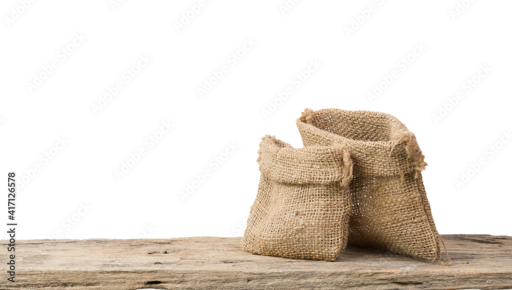 Two different size burlap bags on grunge wooden  shelf with copy space isolated over white background