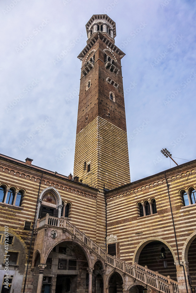Medieval Torre del Comune (or Torre dei Lamberti, 1464) in the middle of Market's square (Piazza delle Erbe). Verona, Veneto region, Italy.